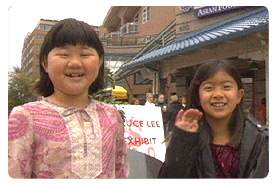 Two girls smiling and waving