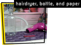 photo of hair dryer, bottle, and paper