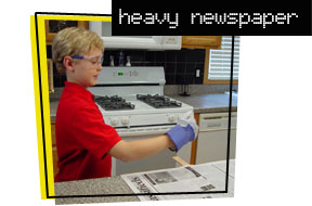 boy with a stick and a newspaper