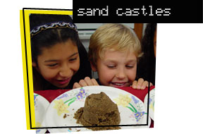 kids looking at sandcastles