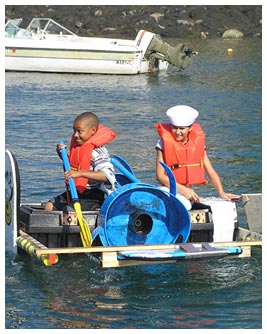 Khalil and Julia in a raft with paddles.