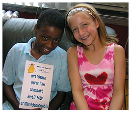 Mike and Madi holding up the list of words they used to write their rap.