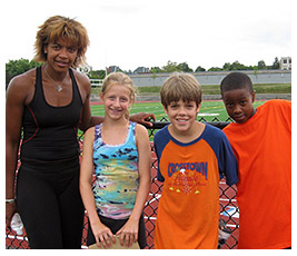 Madi, Willie, and Mike with their personal trainer on the track.
