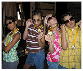 Nina, Bridget, Madi, and Rosario wearing shades and VIF (Very Important FETCHers) medals.