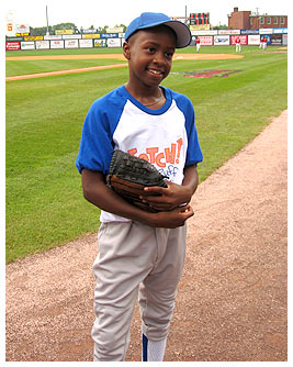 Mike pitching at a baseball game.