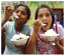 Harsha and Sammy eating ice cream sundaes.