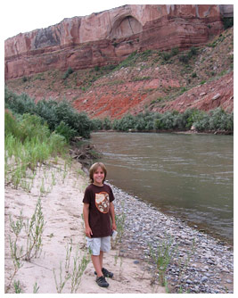 Sam in front of a river and mountain in Utah.