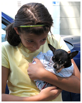 Sammy holding a chihuahua in her arms.