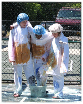 Jay, Sam, and DJ standing in a bucket of ice cream with food-stained clothes.