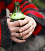 Hands holding a beer bottle