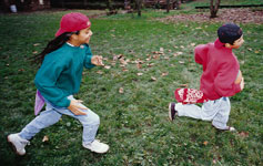 Girl chasing younger boy