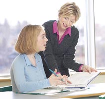 Girl getting help from teacher