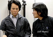 Hiroshi Ishiguro stares into the face of his android twin