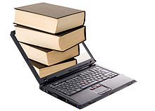 Photo of a stack of books coming out of a laptop