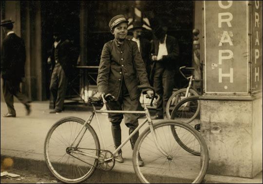 A postal telegraph messenger with his bike.