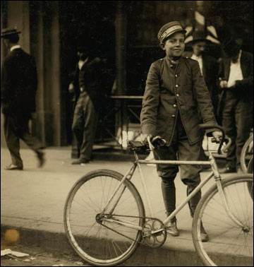 A postal telegraph messenger with his bike.