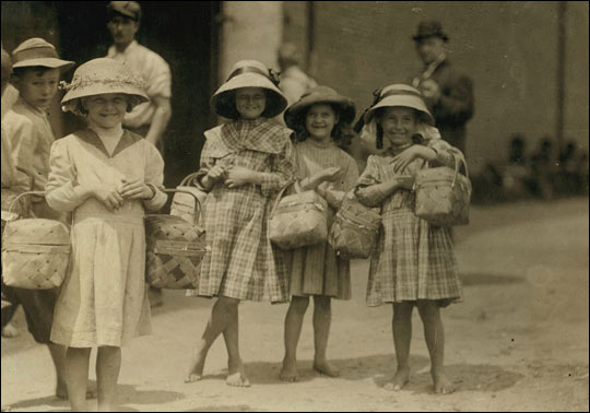 Barefoot girls carrying food.
