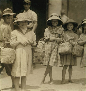 Barefoot girls carrying food.